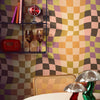 Roomset close-up of pyschedelic check wallpaper in retro tones