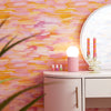 Roomset close-up of brushstroke wallpaper in vibrant pink, orange and yellow colourway