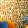 Roomset close-up of matisse pattern wallpaper in earthy orange, toffee and mustard colourway