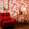 Roomset of matisse pattern wallpaper in peach, chilli and seaweed green colourway