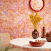 Roomset close-up of contemporary 70s, mehndi design wallpaper in hot pink and orange colourway