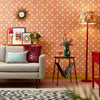 Roomset close-up of 70s geometric wallpaper in mustard, red and subtle pink colourway