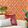 Roomset of 70s geometric wallpaper in mustard, red and subtle pink colourway